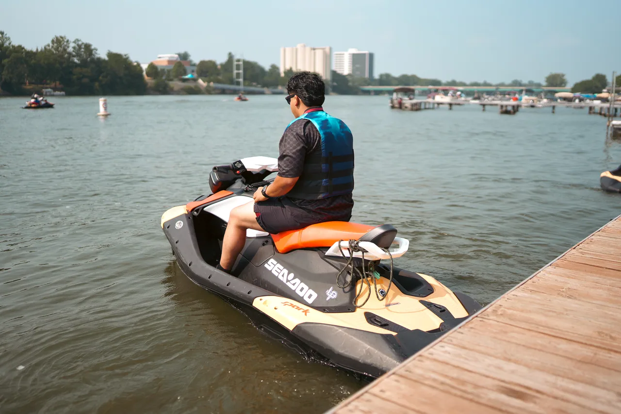 A rider carving on the Rock River with downtown Rockford behind
